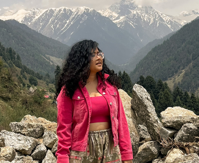 Girl standing on top of Mountain in Gir
