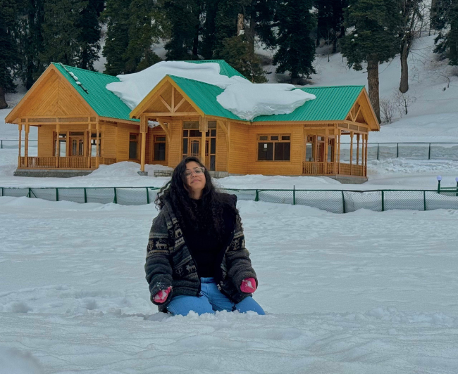 Girl sitting in snow in Kashmir