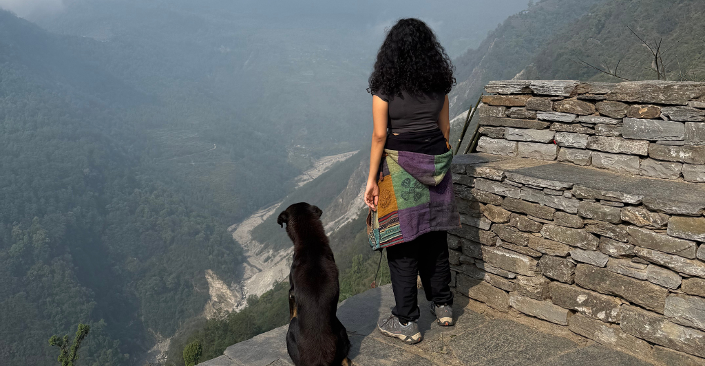 Girl posing with dog on Annapurna base camp Girl posing with dog on Annapurna base camp