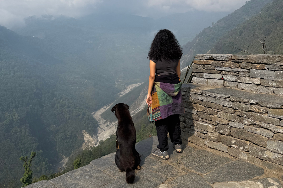 Girl posing with dog on Annapurna base camp Girl posing with dog on Annapurna base camp